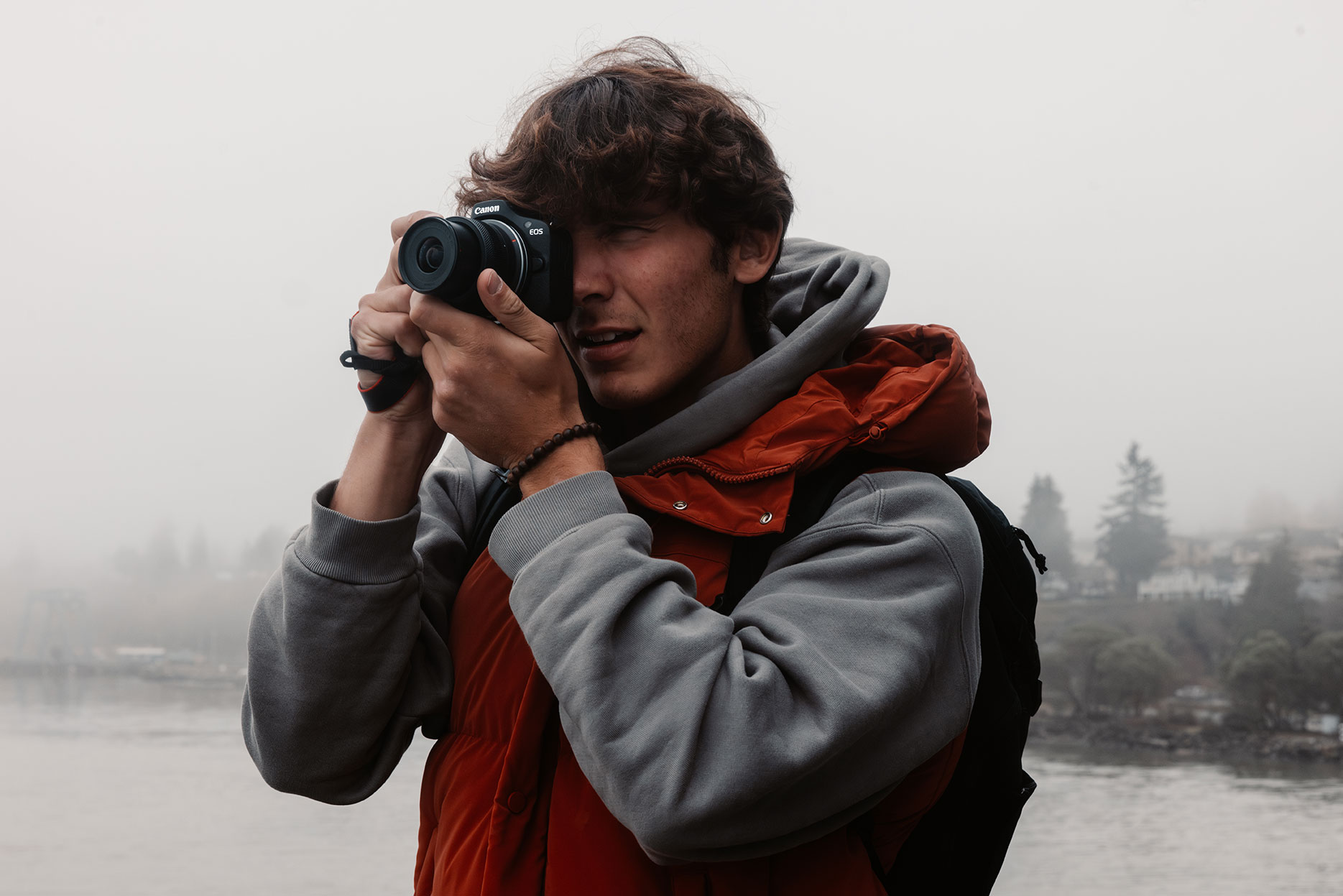 young man shooting with a canon camera