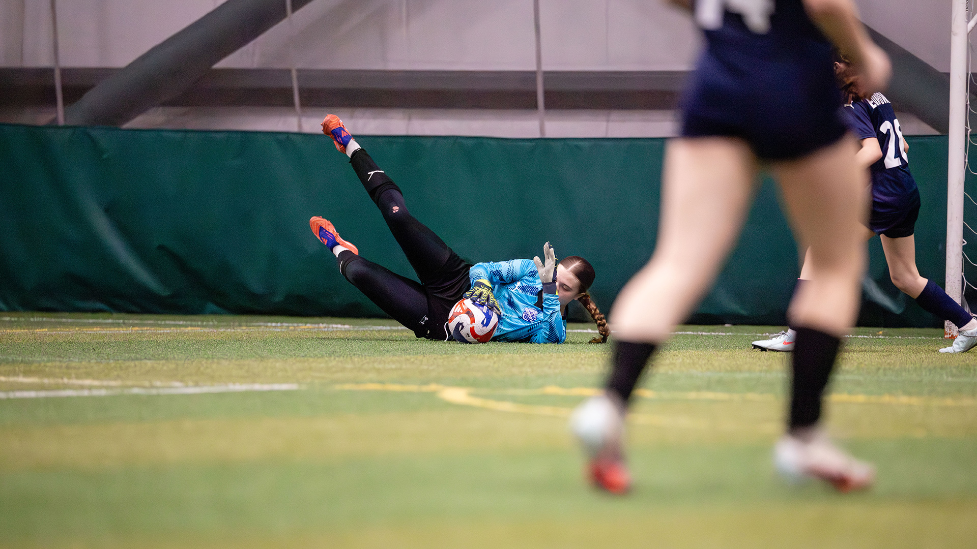 girl goalie blocking a kick