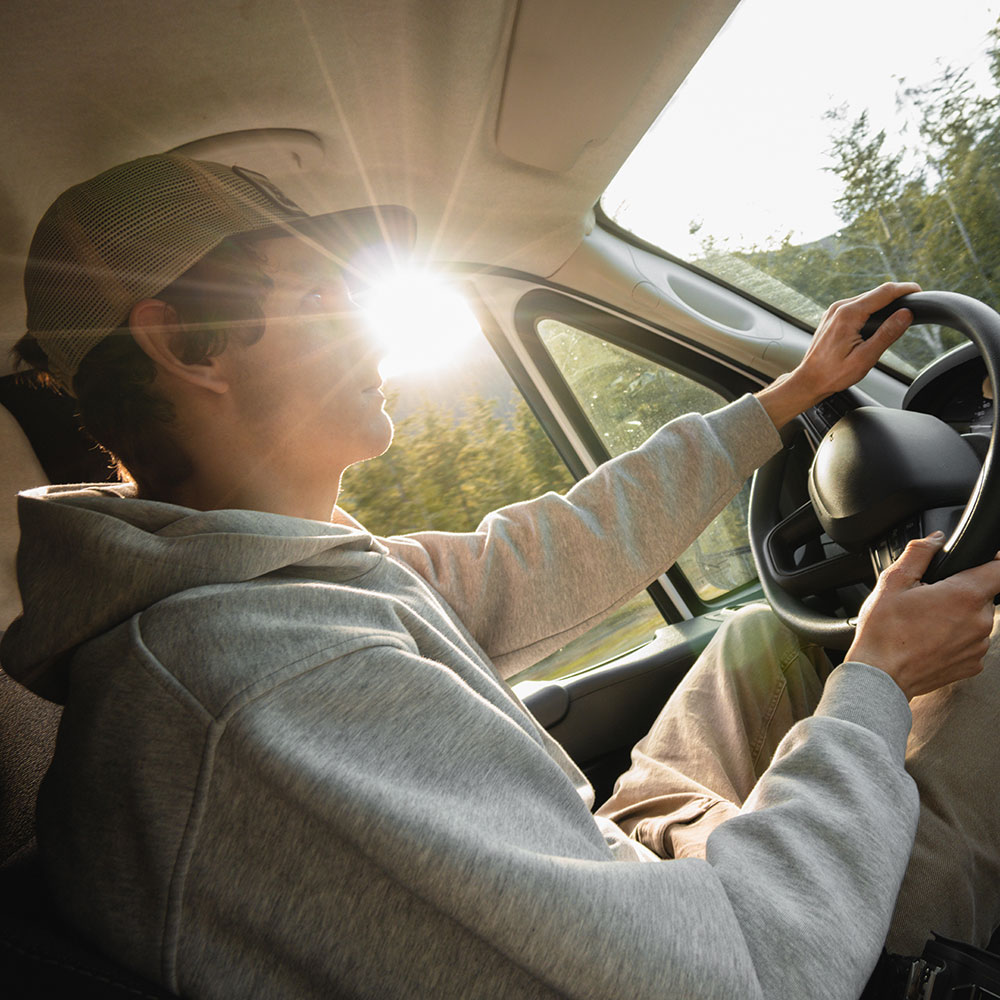 shot of man driving in the forest