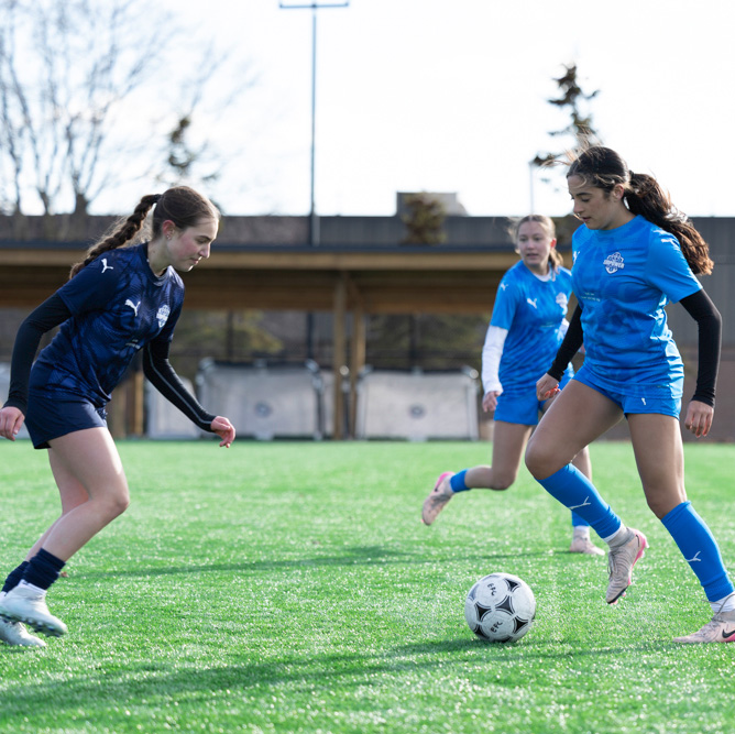 2 girls playing soccer