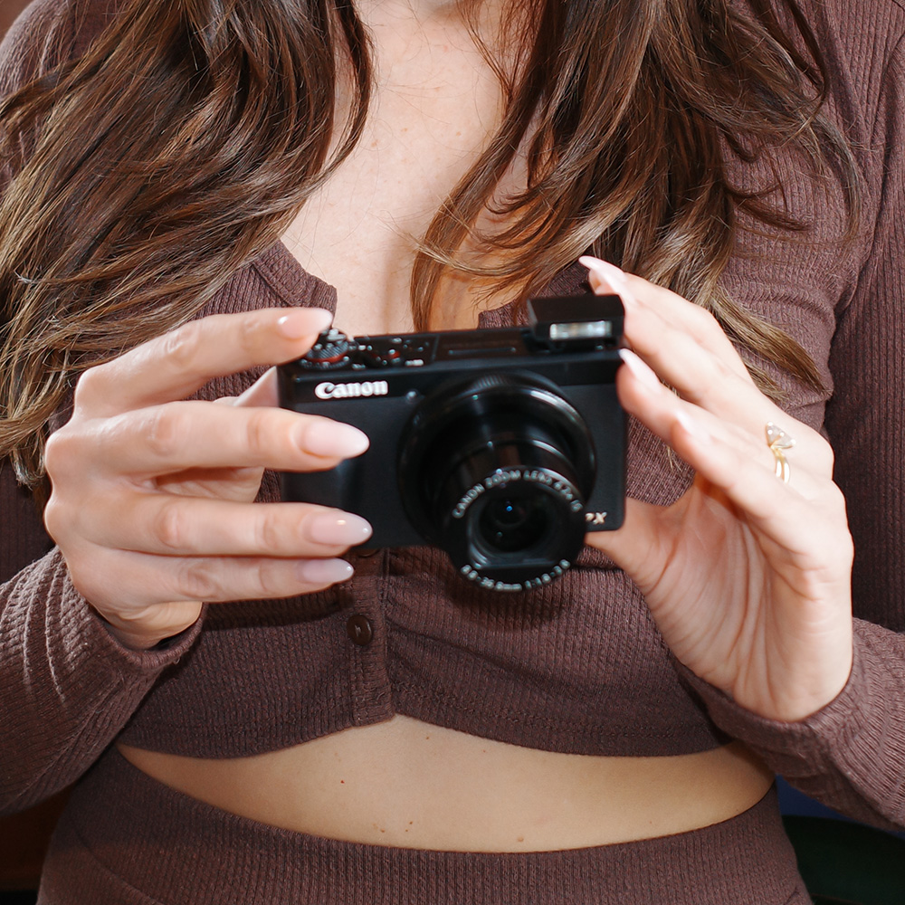 woman holding a Powershot G7 X Mark III