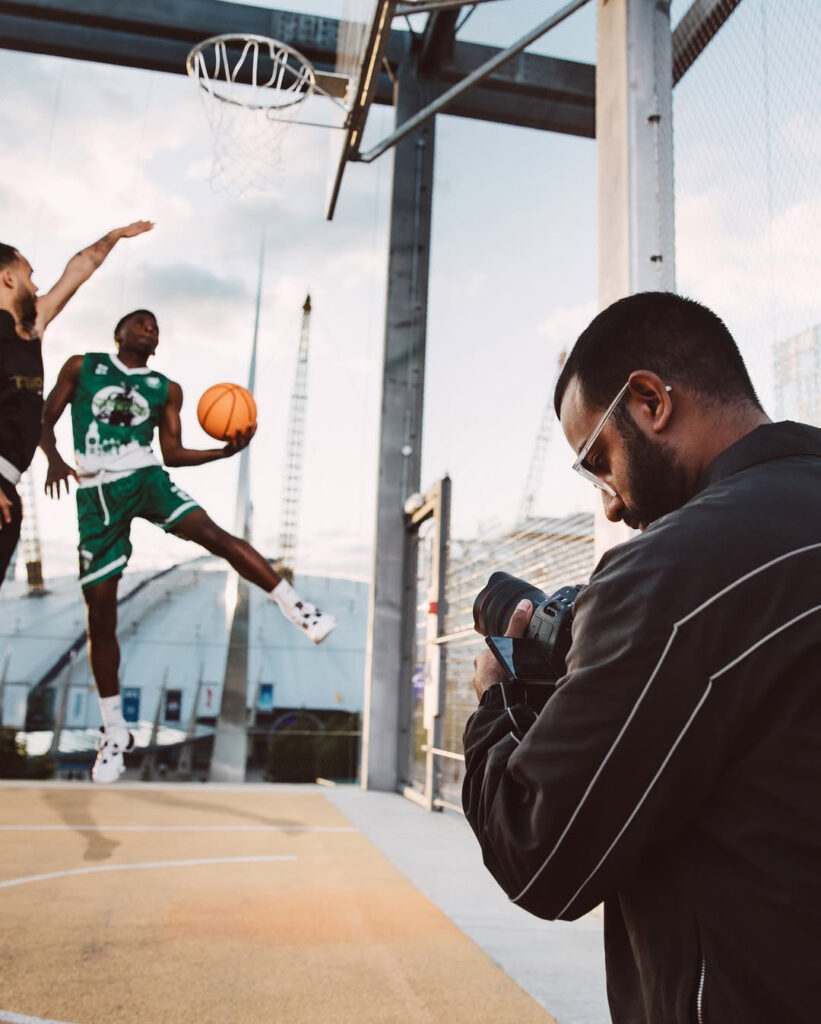 kishan shooting a photo of 2 basketball players outdoors