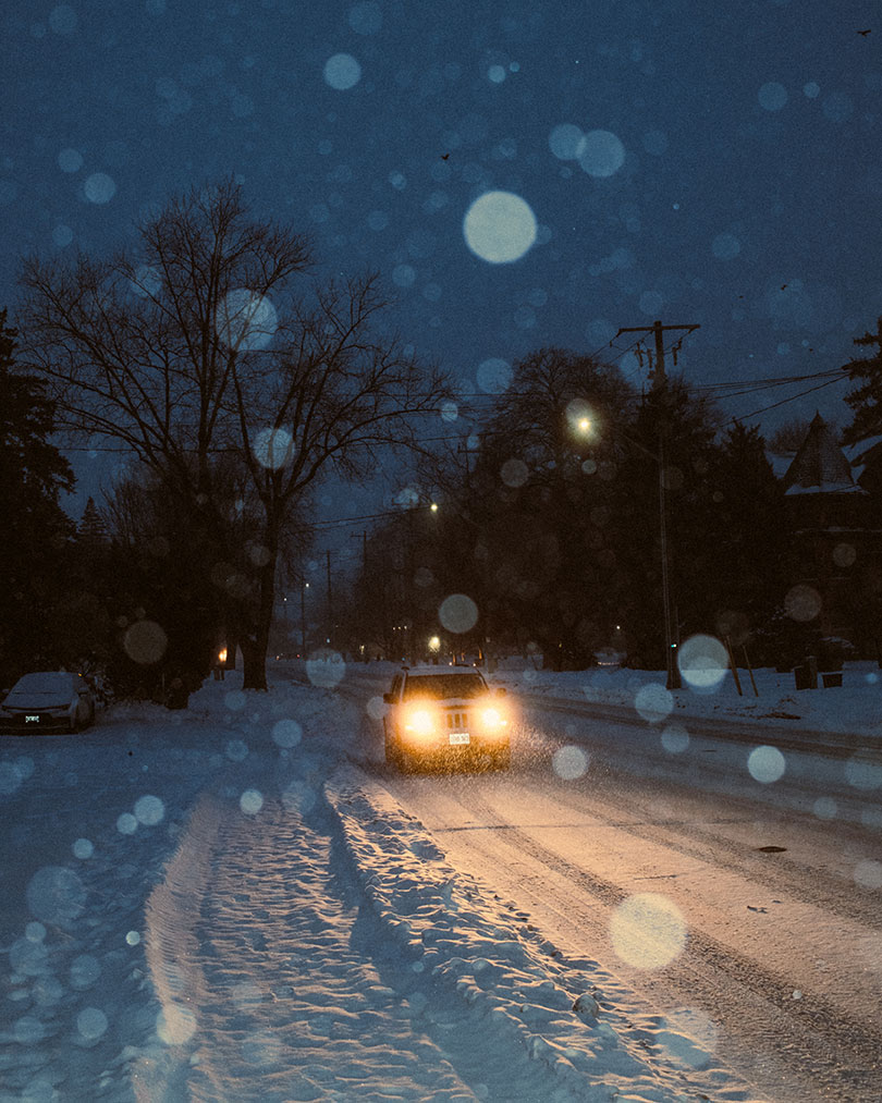 car driving in the snowy night