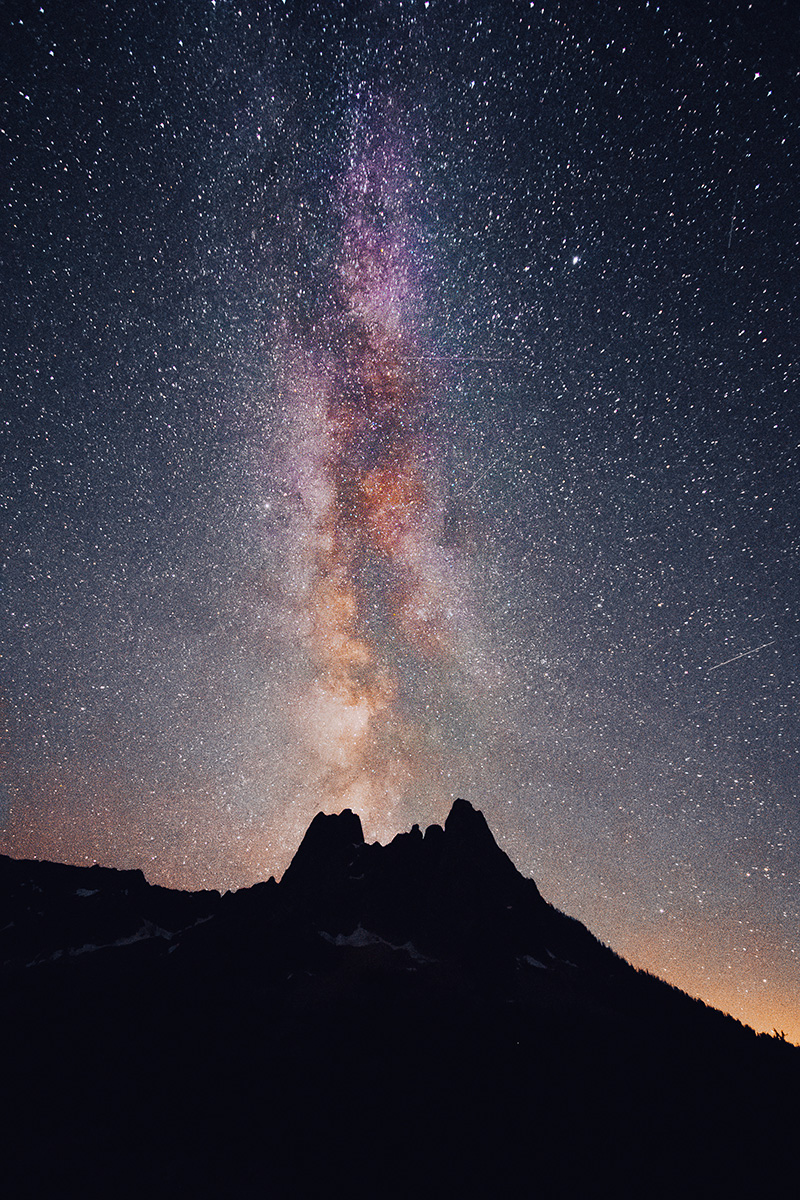 mountain silhouette against a starry night sky