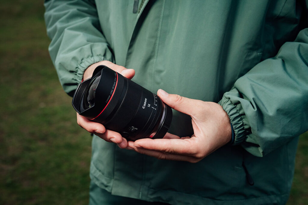man holding a RF14mm F1.4 L VCM